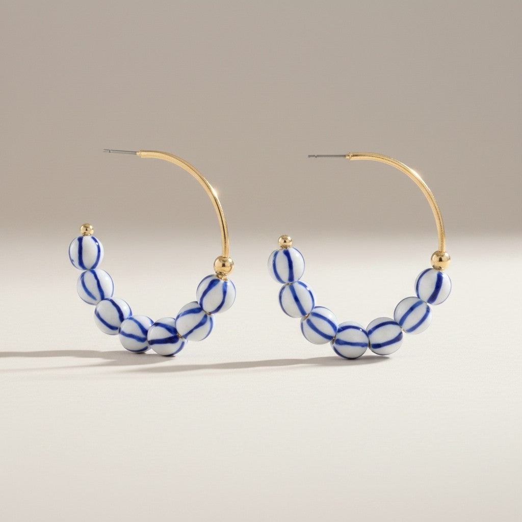 Everly Davis blue and white striped ball hoop earrings with gold accents. 1 1/2" length.