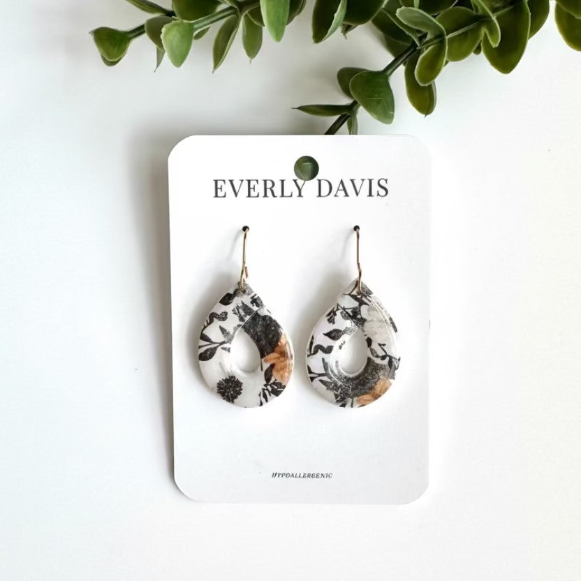 Everly Davis teardrop clay earrings with a dark floral pattern in black, white, and tan. Hypoallergenic.