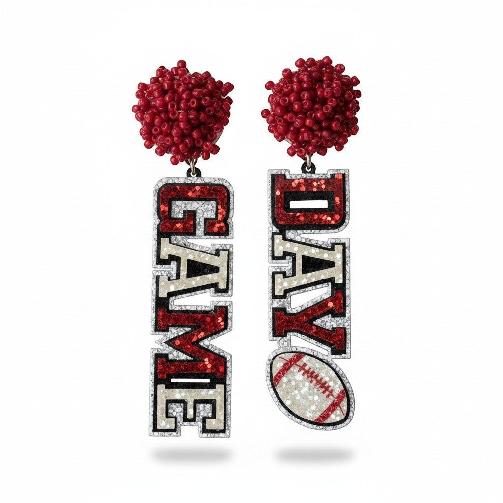 Everly Davis Game Day glitter earrings with red beaded tops and "GAME DAY" lettering, featuring a football accent.