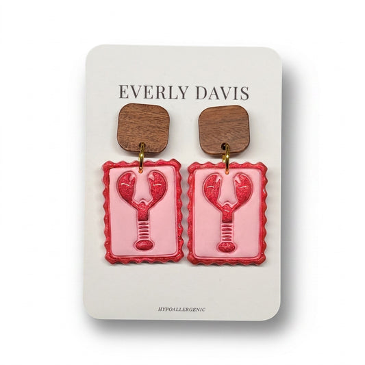 Everly Davis pink and red lobster stamp earrings with wooden square tops.