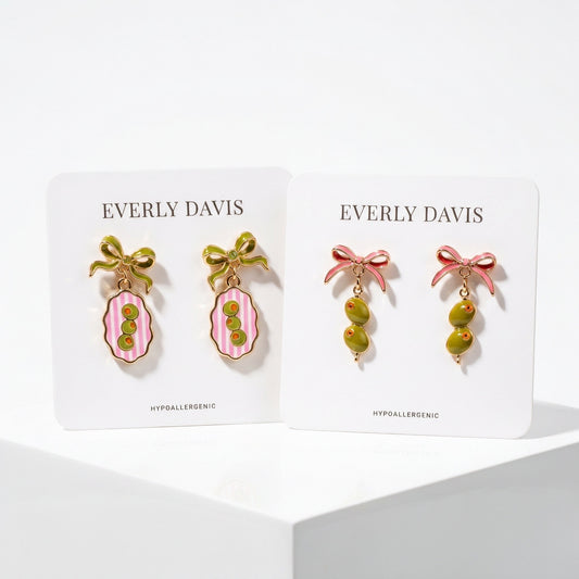 Everly Davis olive and pink striped oval earrings and olive drop earrings with pink bows.
