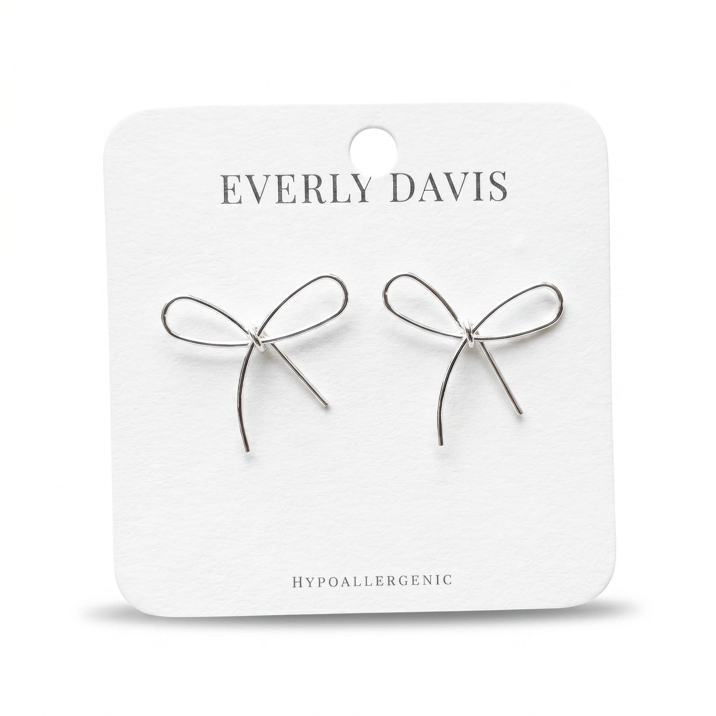 Everly Davis silver metal bow earrings, delicate and minimalist design, hypoallergenic.