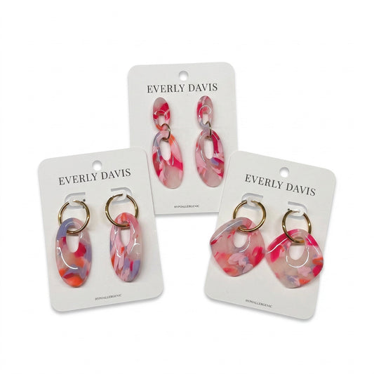 Everly Davis abstract resin hoop earrings in pink, purple, and orange marbled pattern. Lightweight and hypoallergenic.
