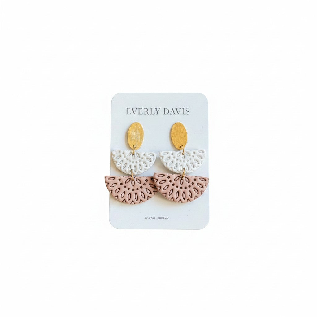 Everly Davis Annie earrings in white and blush pink with gold oval tops and intricate cut-out designs.