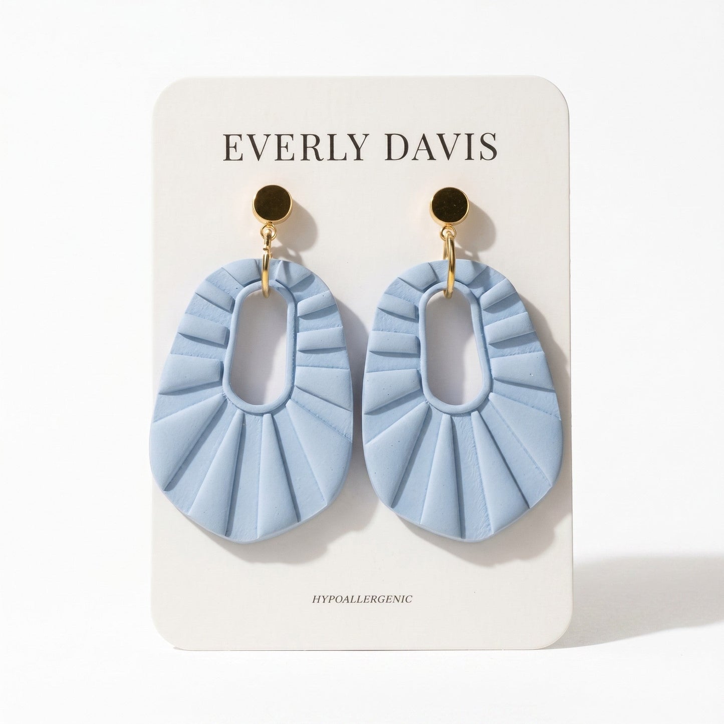 Everly Davis light blue oval statement clay earrings with a pleated fan design and gold-tone posts.