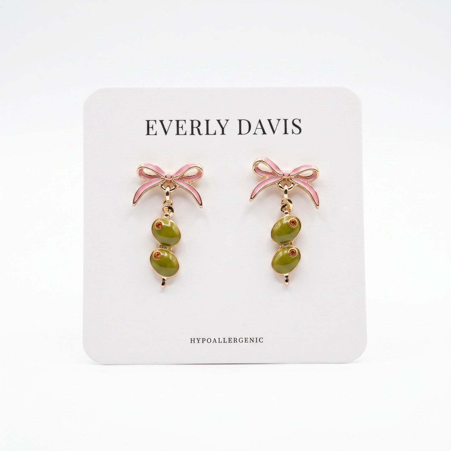 Everly Davis pink bow earrings with dangling olive charms and gold accents.