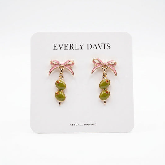 Everly Davis pink bow earrings with dangling olive charms and gold accents.