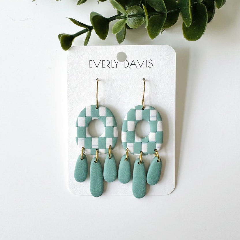 Everly Davis seafoam green and white checkerboard dangle earrings with teardrop charms. Polymer clay.