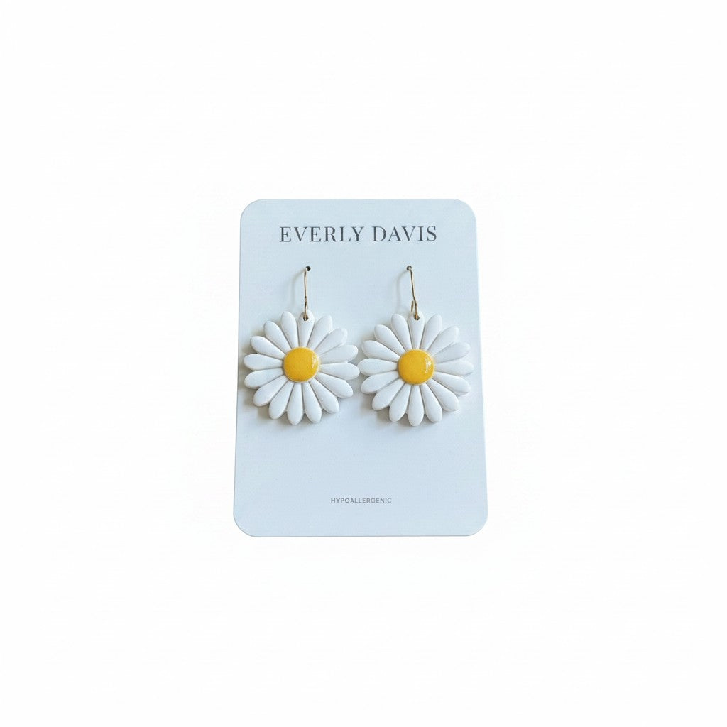 Everly Davis white daisy flower earrings with yellow centers, handcrafted from lightweight clay. Hypoallergenic and nickel-free.
