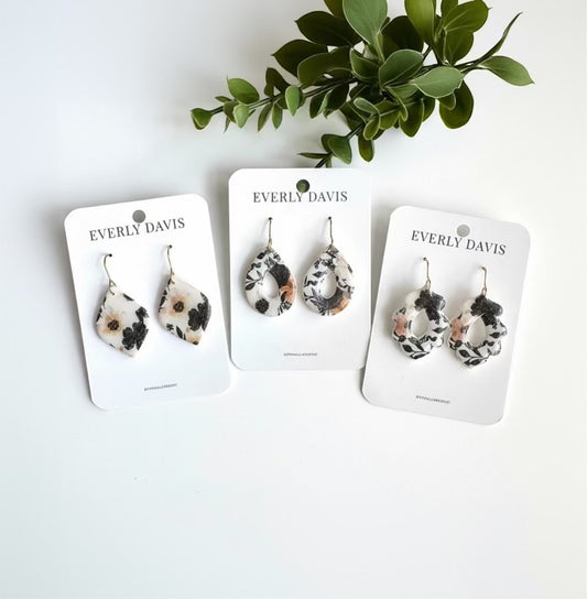 Everly Davis dark floral patterned polymer clay earrings in teardrop and abstract shapes.