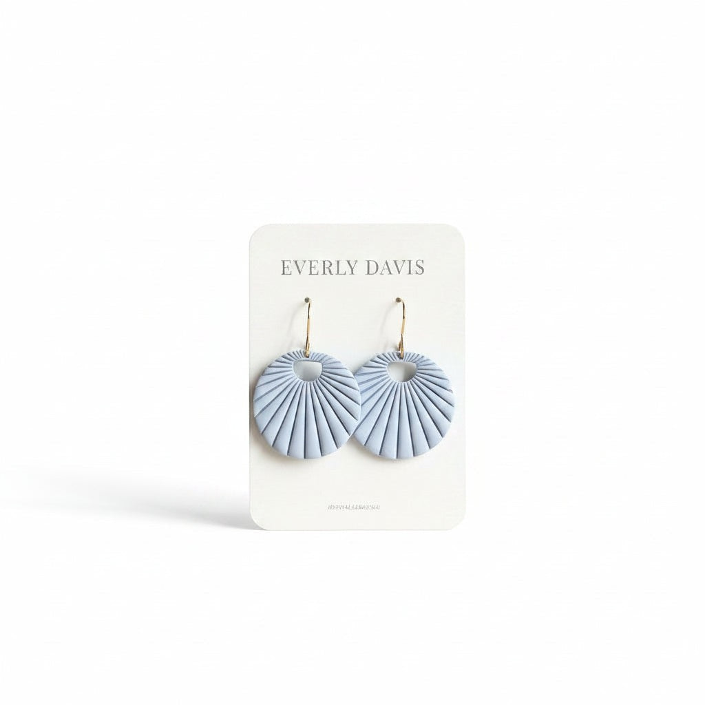 Everly Davis baby blue fan shaped statement earrings made of polymer clay with gold hooks.