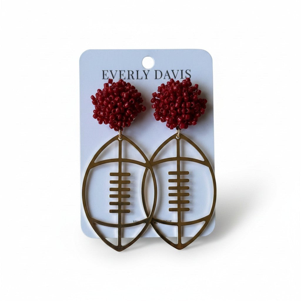 Everly Davis gold football open dangle earrings with red beaded tops. 2 1/4" length.