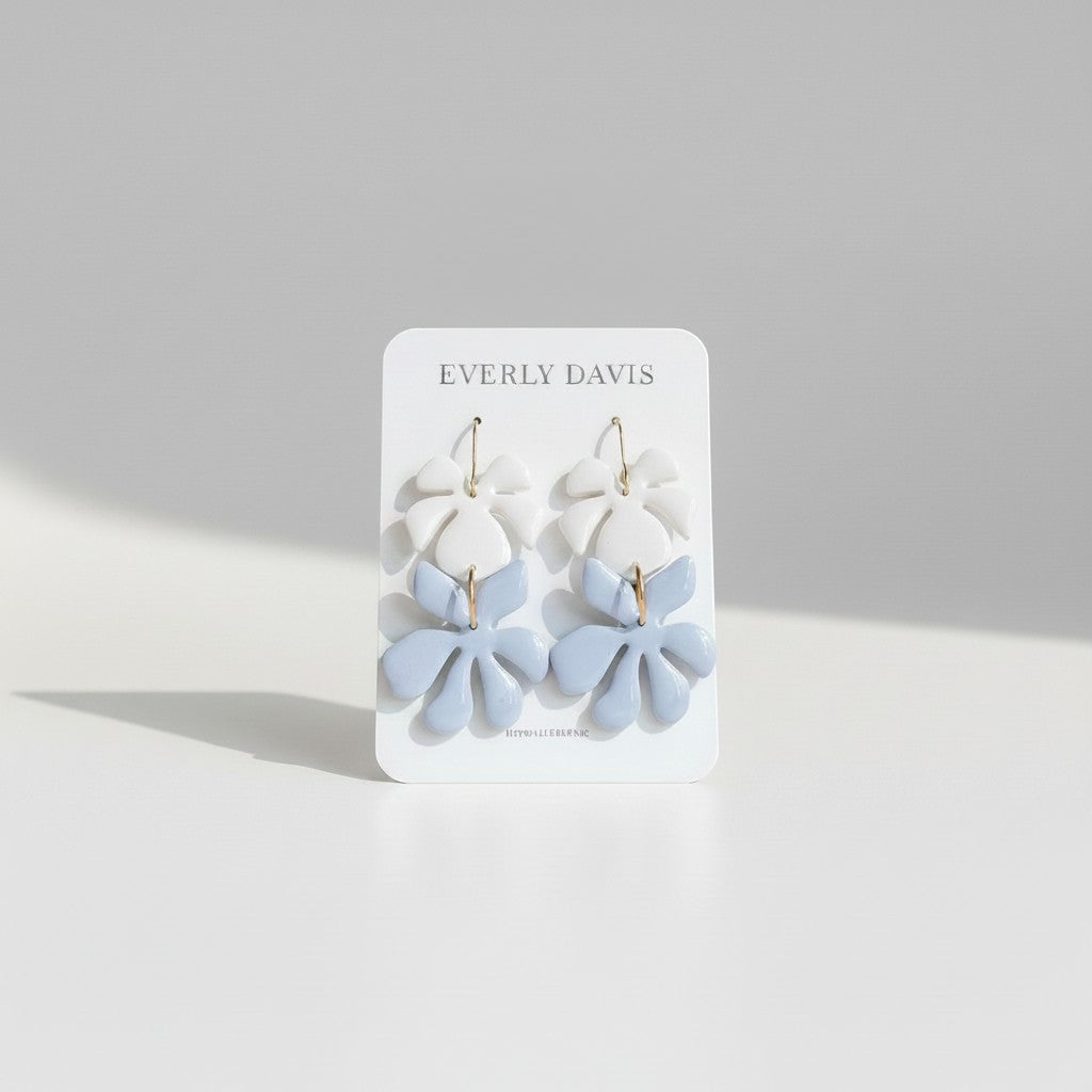 Everly Davis Leah leaf motif earrings in white and light blue clay, lightweight and elegant for any occasion.