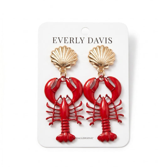 Everly Davis red acrylic lobster dangle earrings with gold shell tops. Fun, whimsical statement jewelry.