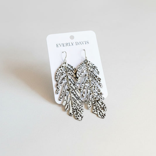 Everly Davis Moira Dangles, white and black spotted leaf-shaped drop earrings.