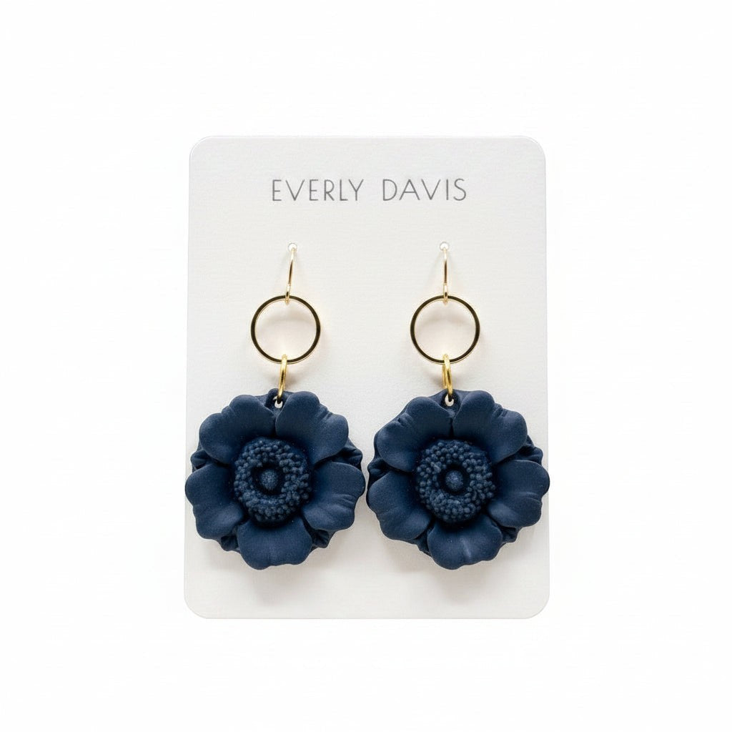 Everly Davis navy blue floral statement earrings with gold-tone hoops, made from polymer clay.