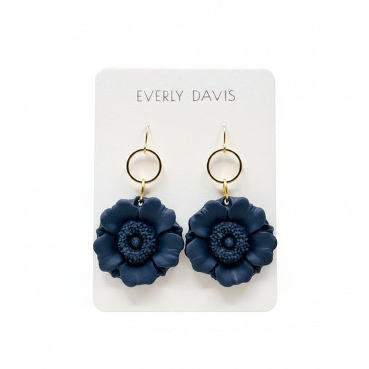 Everly Davis navy blue floral statement earrings with gold-tone hoops, made from polymer clay.