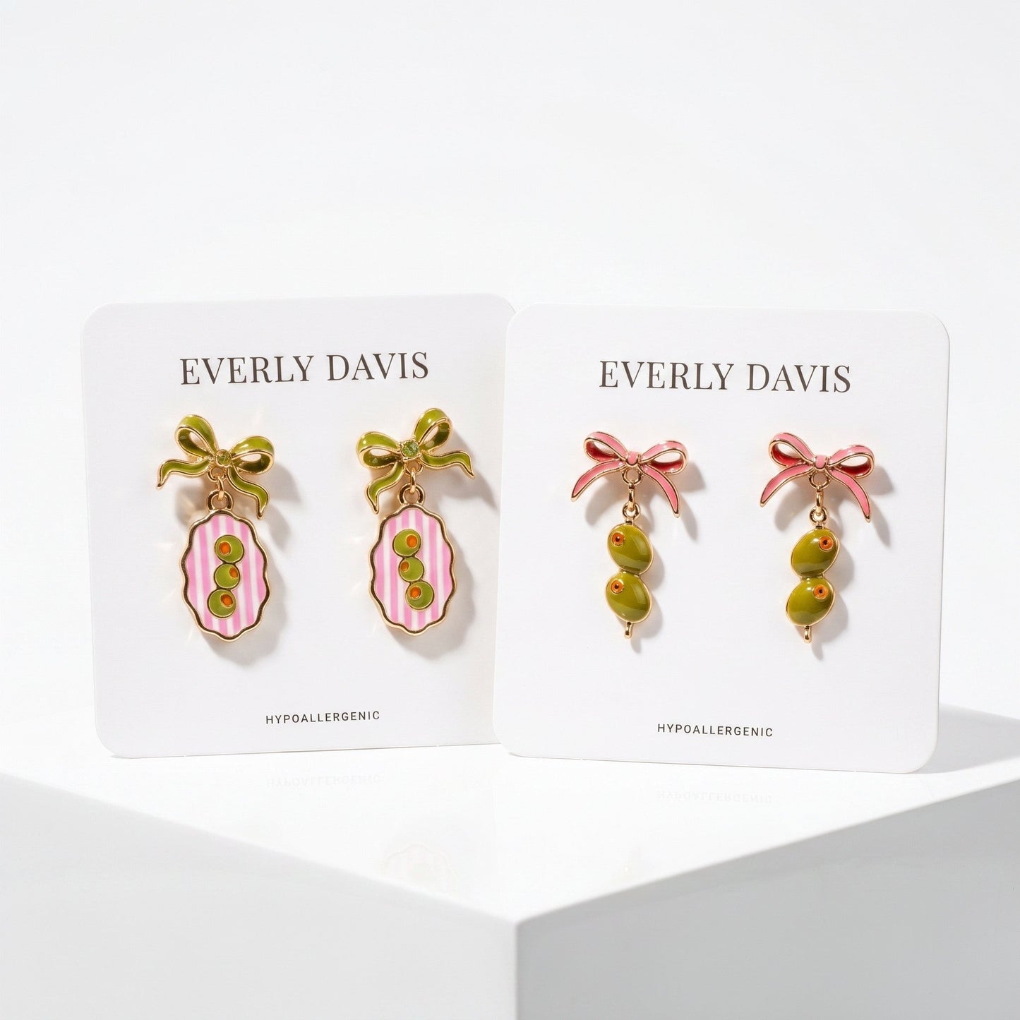 Everly Davis olive and pink striped oval earrings and olive drop earrings with pink bows.