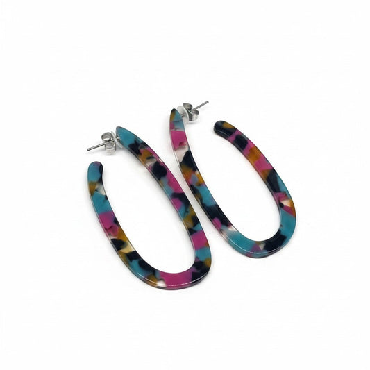 Everly Davis oval resin hoop earrings in a multicolor tortoiseshell pattern with pink, teal, and black accents.