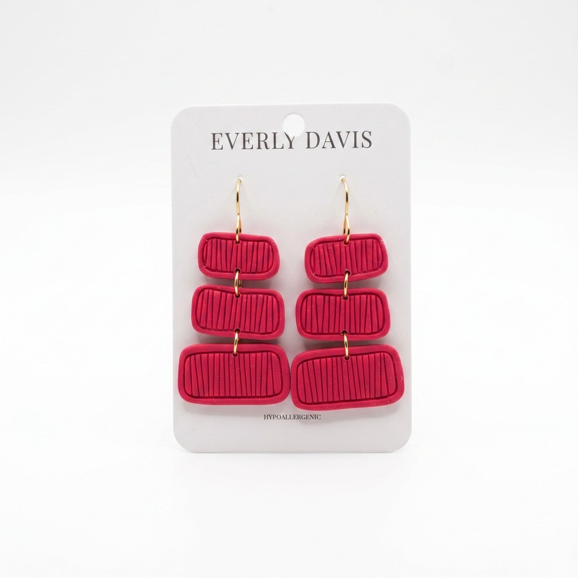 Everly Davis Pammi red clay dangle earrings with textured horizontal lines and gold hooks.