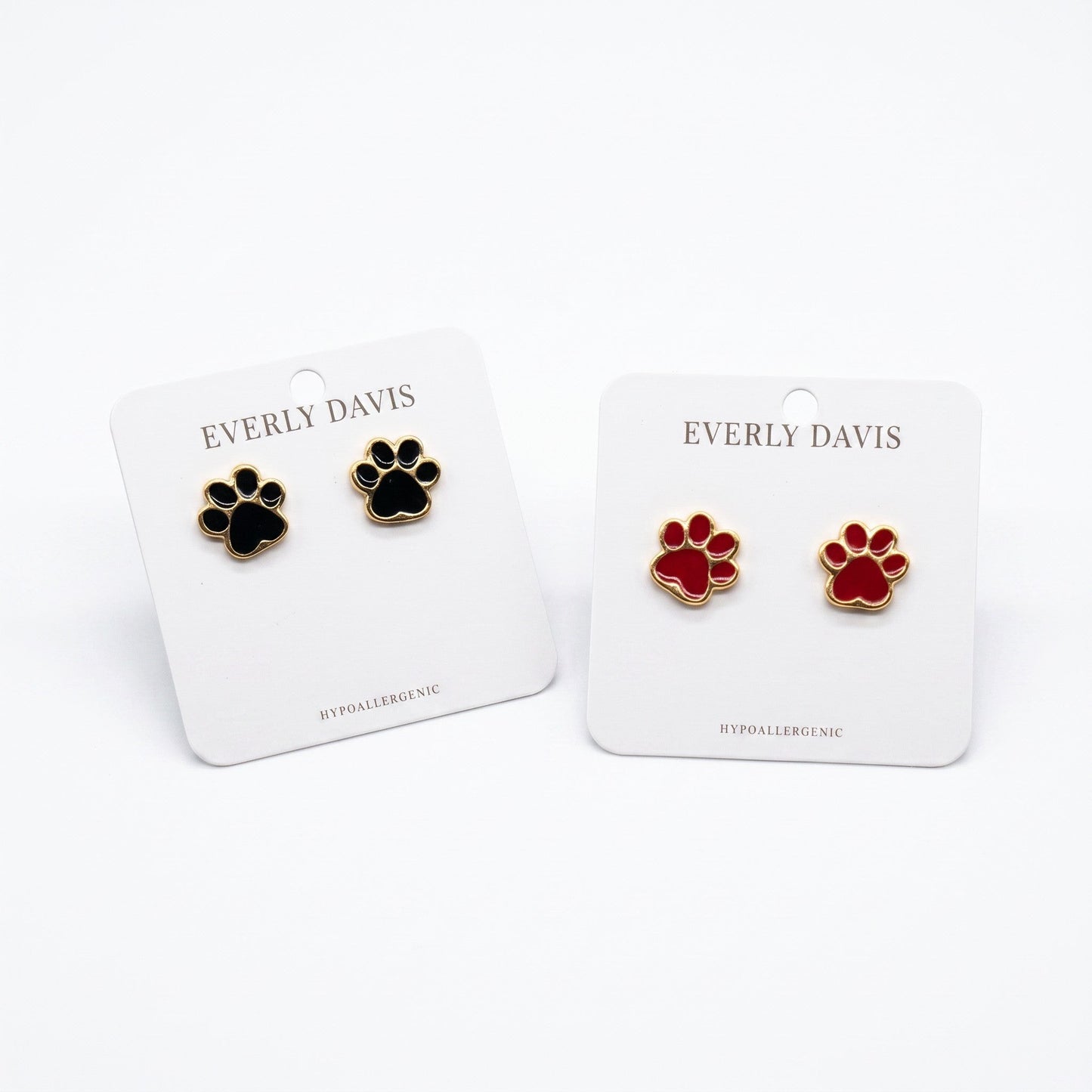 Everly Davis black and red paw print stud earrings, crafted from metal with gold trim. Hypoallergenic.