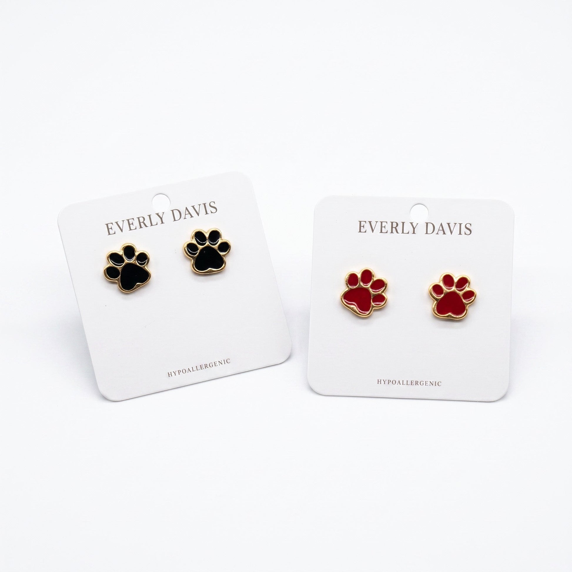 Everly Davis black and red paw print stud earrings, crafted from metal with gold trim. Hypoallergenic.
