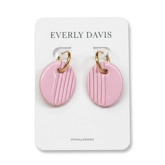 Everly Davis oval pink clay earrings with gold huggie hoops and vertical stripe texture. Hypoallergenic.