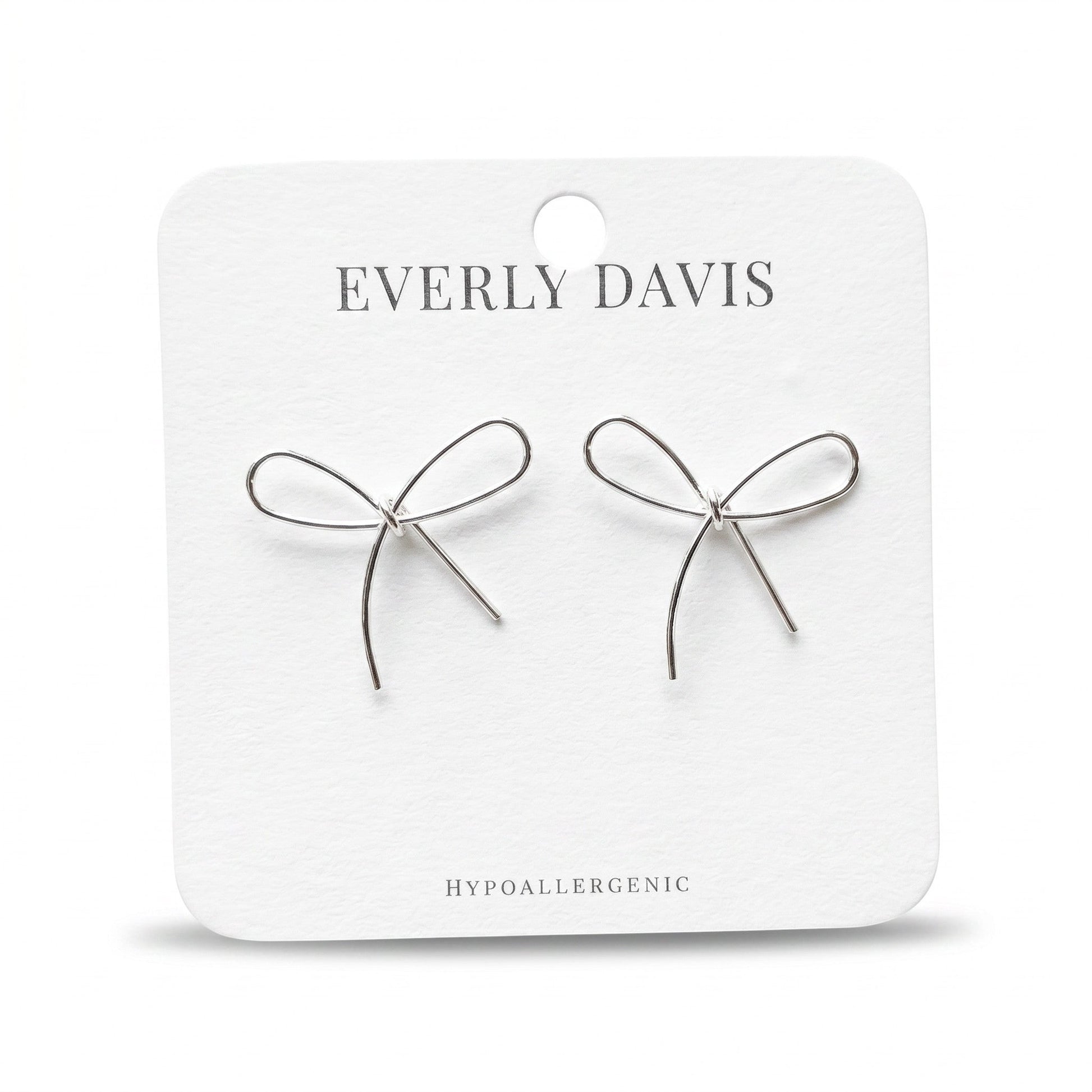 Everly Davis silver metal bow earrings, delicate and minimalist design, hypoallergenic.