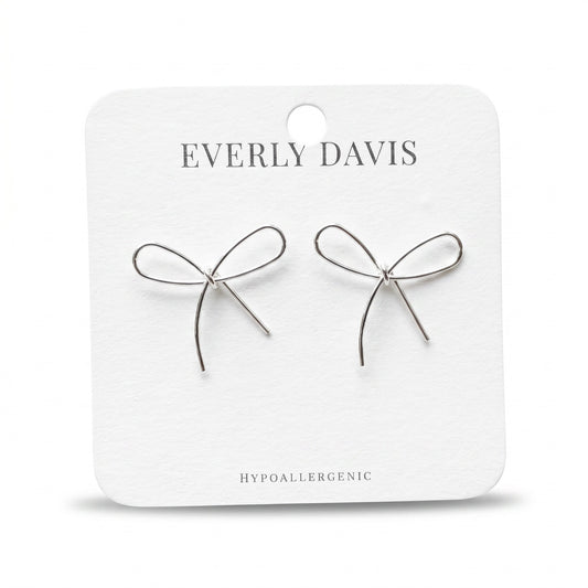 Everly Davis silver metal bow earrings, delicate and minimalist design, hypoallergenic.