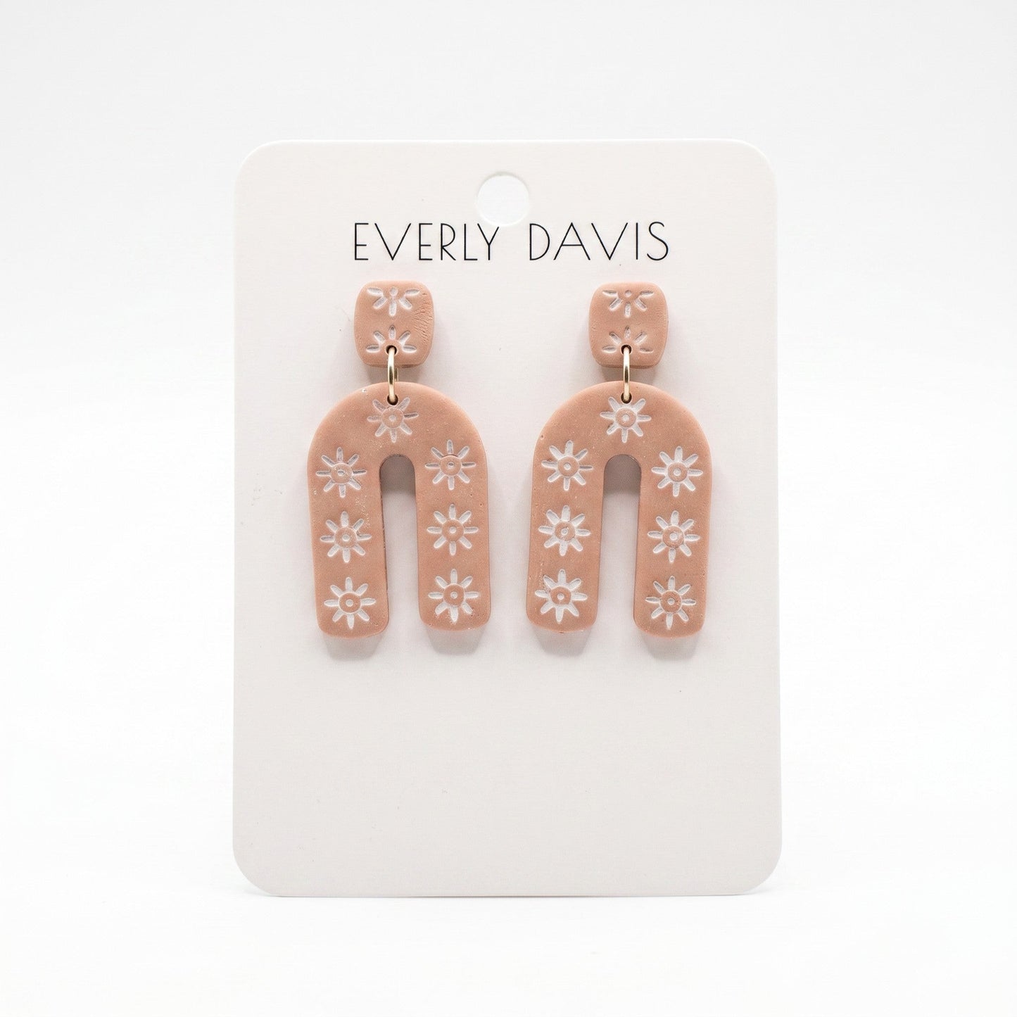 Everly Davis Sophia earrings: terracotta clay with white floral pattern, geometric arch shape, lightweight statement earrings.