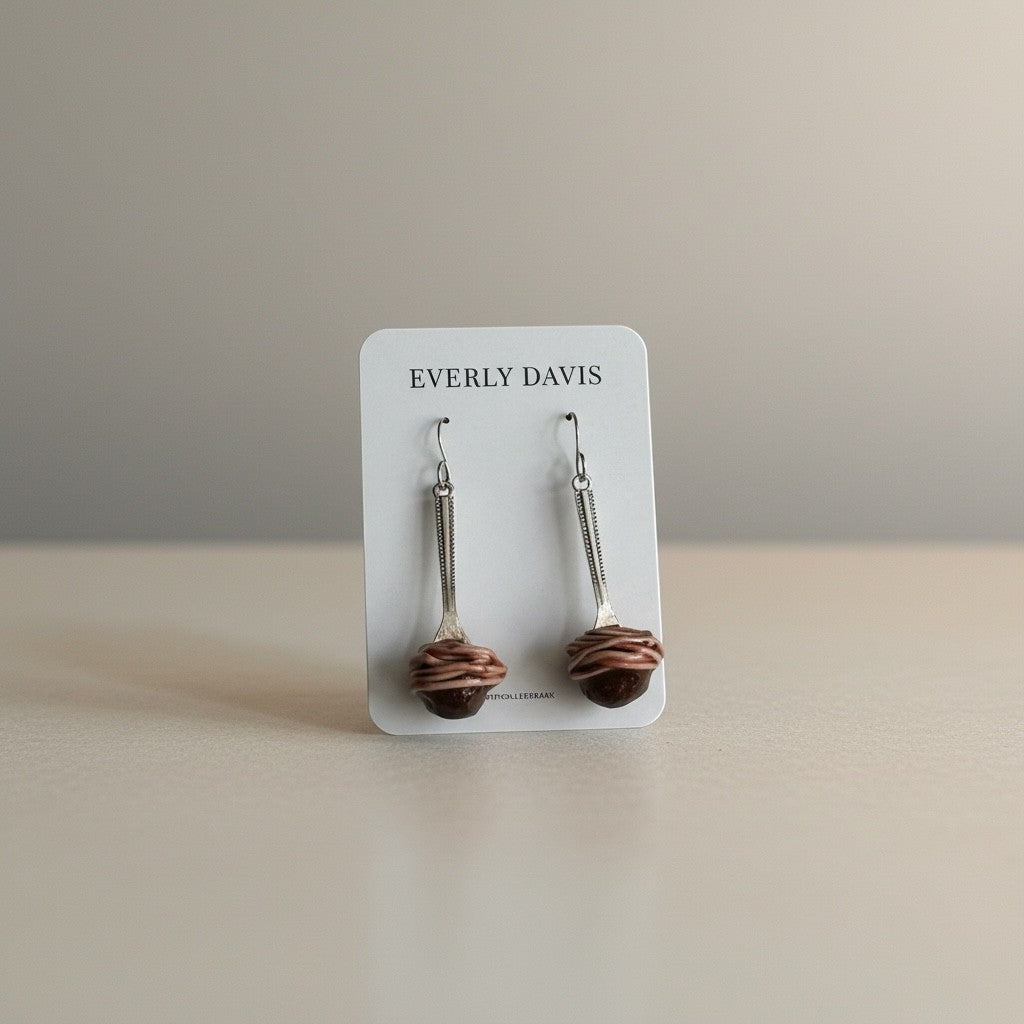 Everly Davis Spaghetti + Meatball Earrings crafted from clay, featuring a meatball with spaghetti strands.