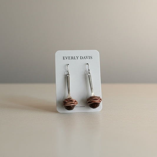 Everly Davis Spaghetti + Meatball Earrings crafted from clay, featuring a meatball with spaghetti strands.