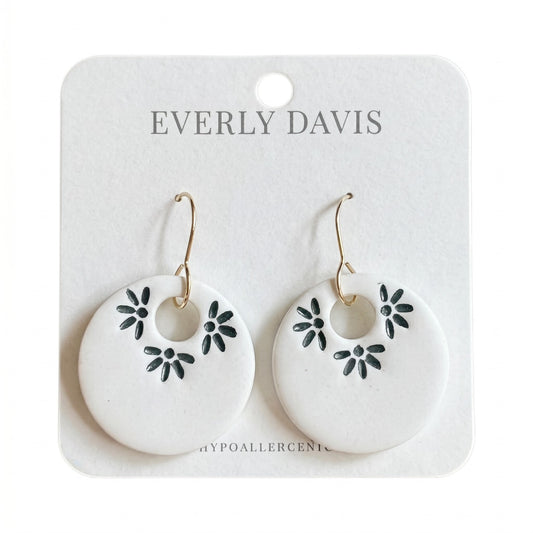 Everly Davis white polymer clay hoop earrings with imprinted dark floral design. Lightweight and hypoallergenic.