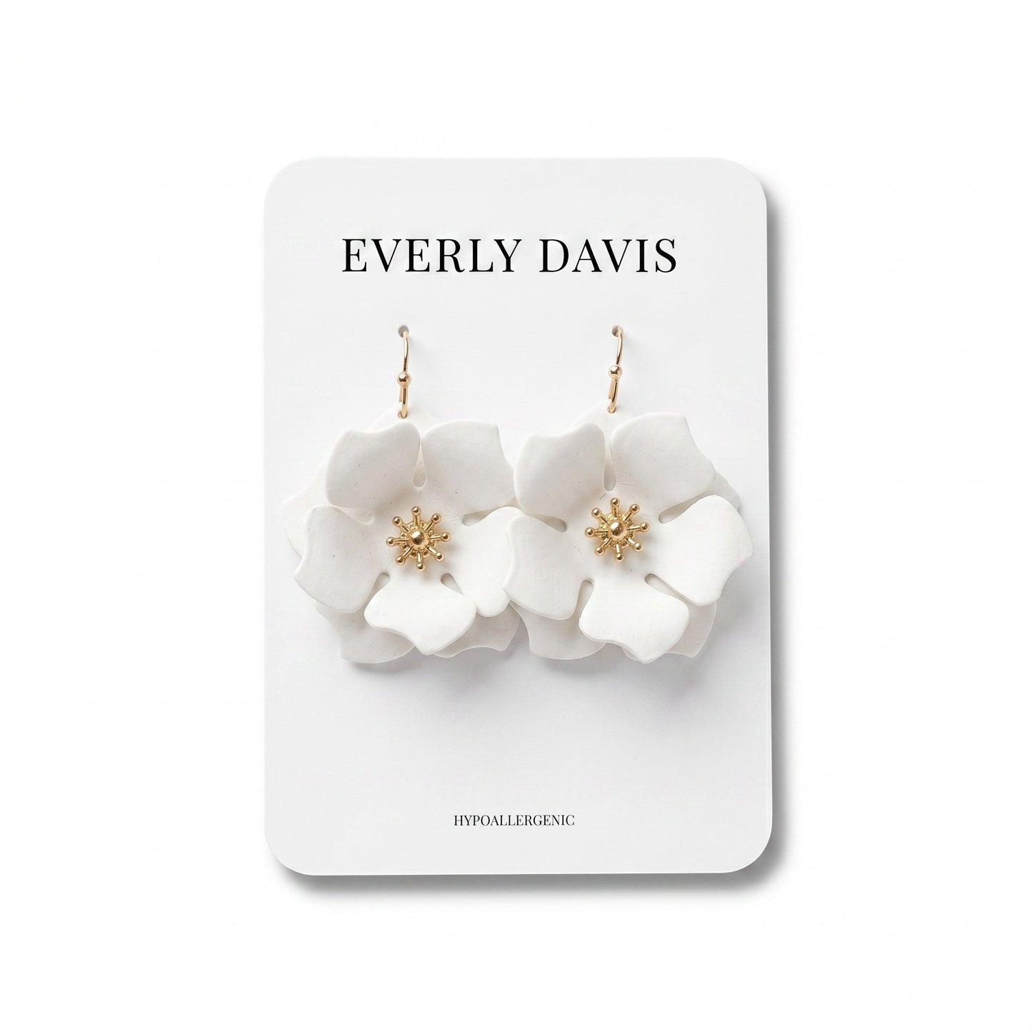 Everly Davis white flower earrings with gold center detail and fish hook closures.