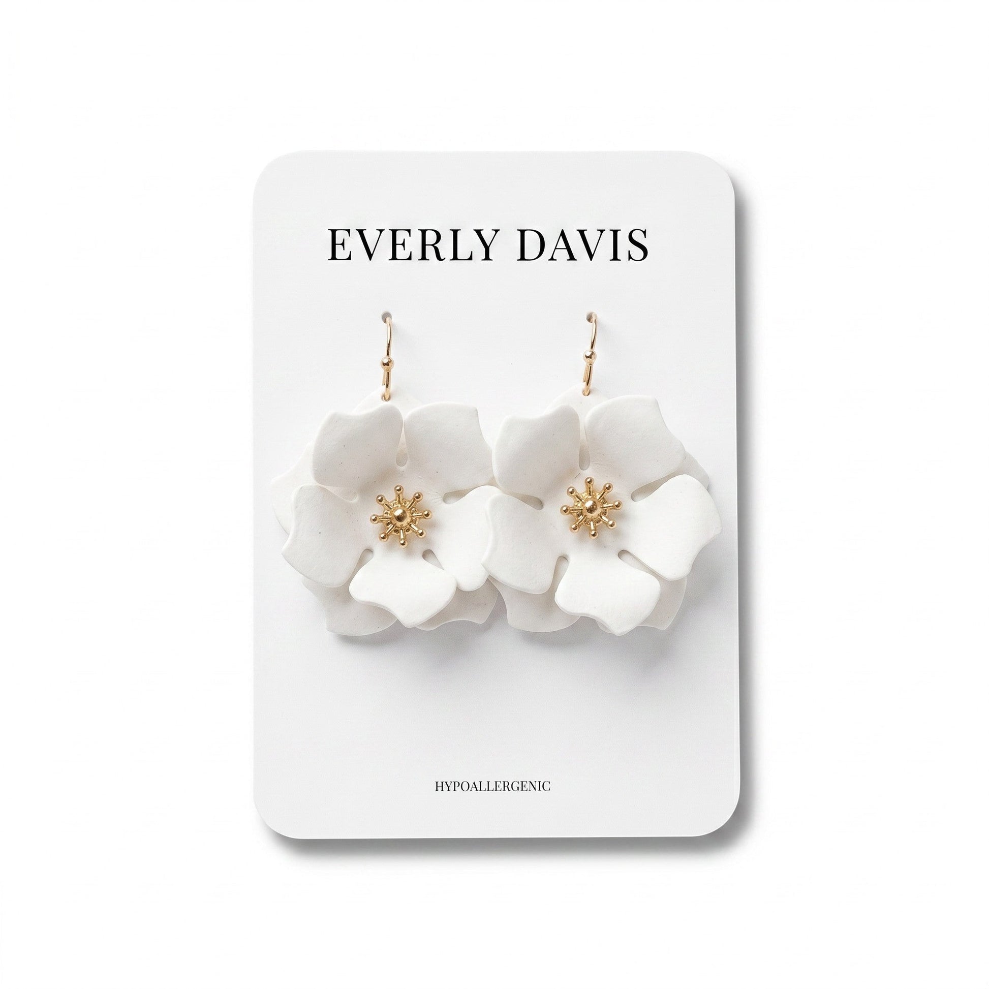 Everly Davis white flower earrings with gold center detail and fish hook closures.