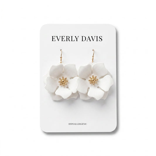 Everly Davis white flower earrings with gold center detail and fish hook closures.