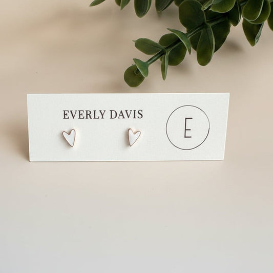 Everly Davis mini white heart stud earrings made from 316L surgical-grade stainless steel.